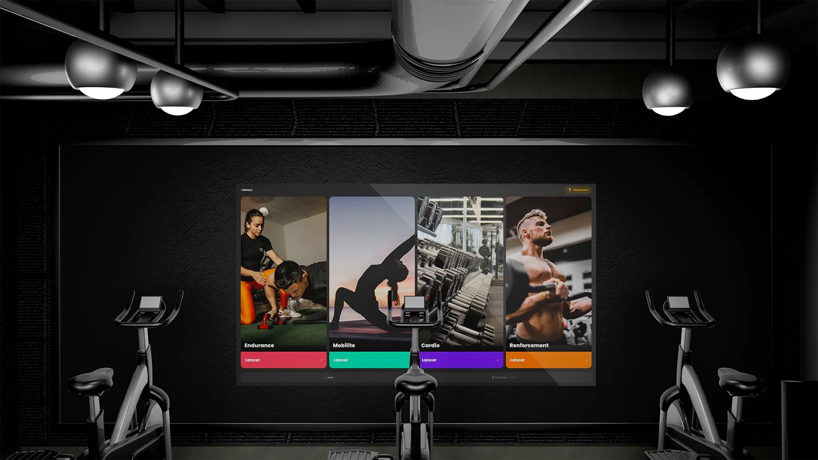 In the gym, the wall screen facing the exercise bikes shows the four disciplines.
